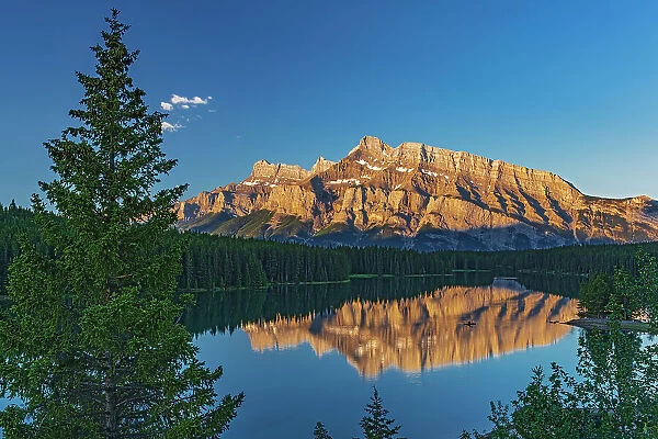 Canada, Alberta, Banff National Park. Mt. Rundle reflected in Two Jack Lake at sunrise