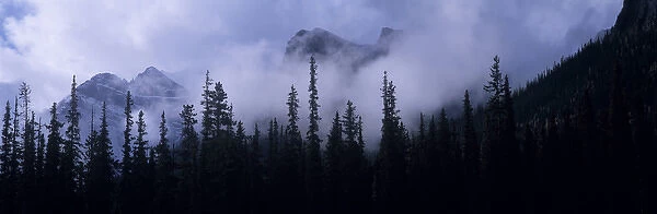 Canada, Alberta, Banff NP. Clouds swirl around mountain peaks above Lake Louise Junction