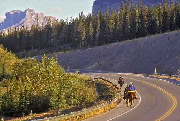 Canada, Alberta, Baniff National Park. People riding horses on road in Baniff National Park