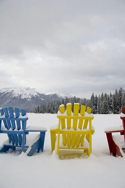 Canada, Alberta, Jasper, Jasper NP. Fairmont Jasper Park Lodge. Colorful chairs around frozen lake