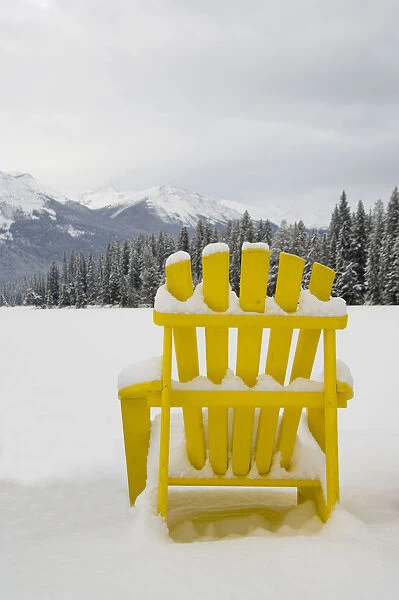 Canada, Alberta, Jasper, Jasper NP. Fairmont Jasper Park Lodge. Colorful chairs around frozen lake
