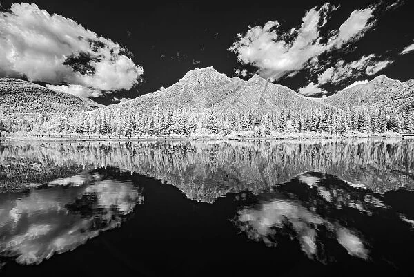 Canada, Alberta, Kananaskis Provincial Park. Black and white of clouds reflected in