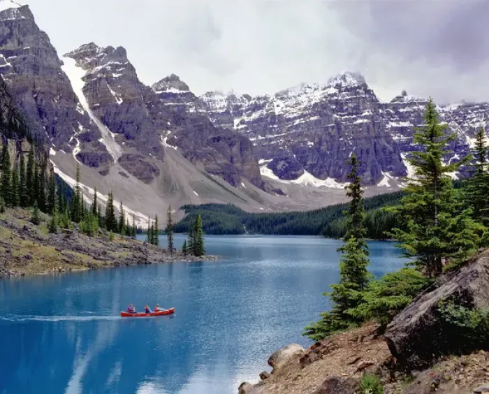 Framed Print : Canada, Alberta, Moraine Lake. A canoe glides across beautiful Moraine Lake in Framed Print : Canada, Alberta, Moraine Lake. A canoe glides across beautiful Moraine Lake in
