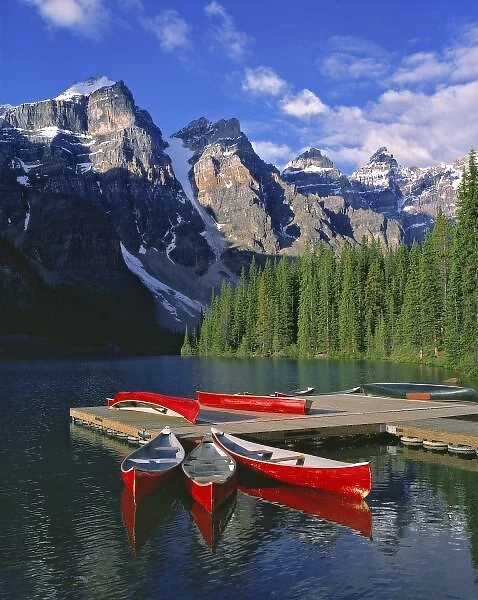 Canada, Alberta, Moraine Lake. Red canoes await canoers at Moraine Lake in the Valley