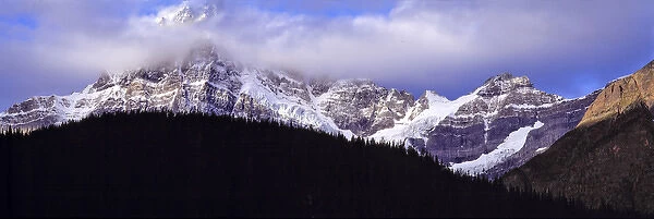 Canada, Alberta, Mt. Chephren. Clouds descend on the snow-marked flanks of Mt. Chephren