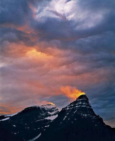 Canada, Alberta, Mt. Chephren. A golden shaft of sunset light ignites a snow plume