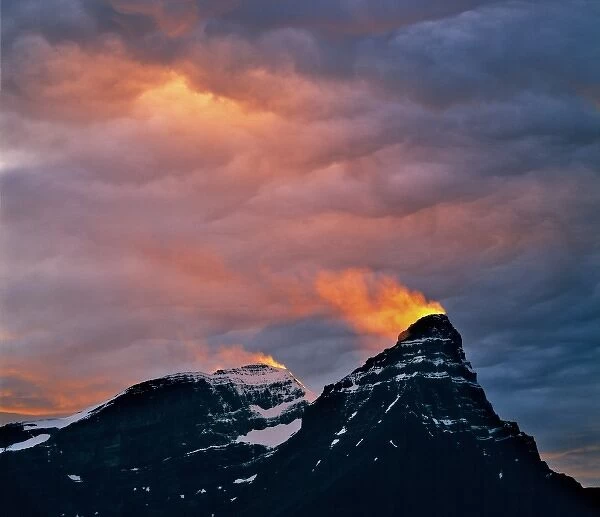Canada, Alberta, Mt. Chephren. A snow plume catches light from the setting sun on Mt