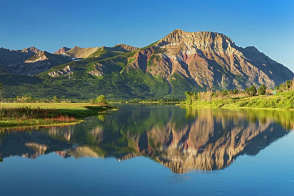 Canada, Alberta, Waterton Lakes National Park. Canadian Rocky Mountains reflected in Lower Waterton Lake