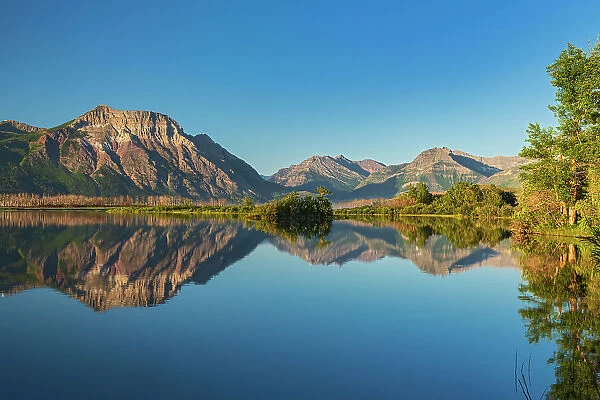Canada, Alberta, Waterton Lakes National Park. Canadian Rocky Mountains reflected in Lower Waterton Lake