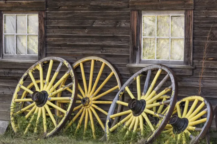 Framed Print : Canada, British Columbia, Barkerville. Wagon wheels lean on old building. Credit as Framed Print : Canada, British Columbia, Barkerville. Wagon wheels lean on old building. Credit as
