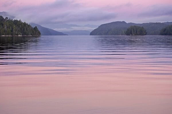 Canada, British Columbia, Calvert Island. Sunset reflections on water