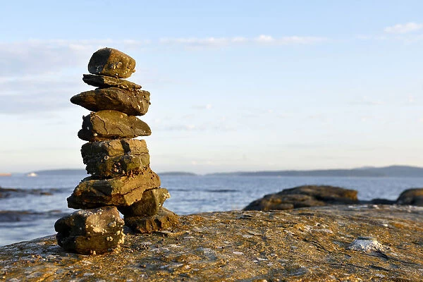 Canada, British Columbia, Russell Island. Rock inukshuk in front of Salt Spring Island