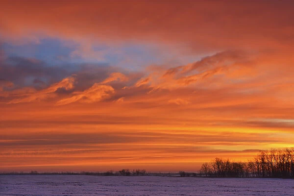Canada, Manitoba, Deacons Corner. Sunrise over the prairie in winter. Credit as