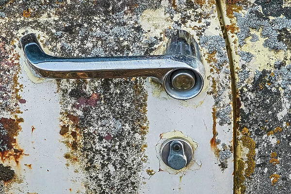 Canada, Manitoba, St. Lupicin. Close-up of rusted paint patterns and handle on vintage car