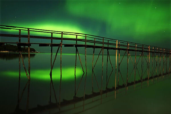 Canada, Manitoba, Winnipeg. Northern Lights reflected in Lake Winnipeg. Credit as