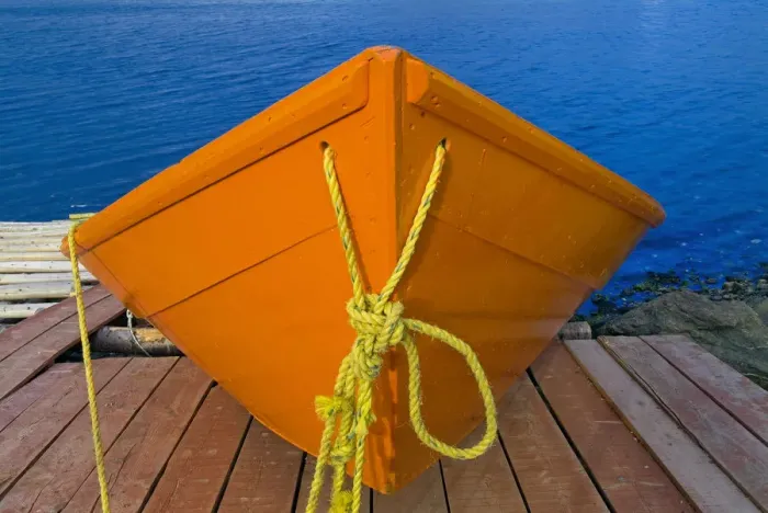 Framed Print : Canada, Newfoundland, Frenchman Cove. Orange boat on dock