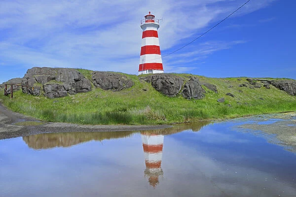 Canada, Nova Scotia, Brier Island. Reflection of Brier Island Lighthouse in pond
