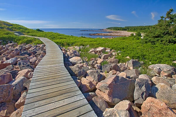Canada, Nova Scotia, Cape Breton Island. Wooden walkway along rocky shoreline