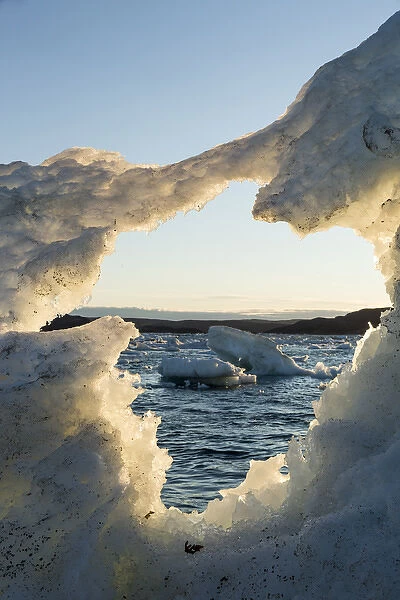Canada, Nunavut, Territory, View of White Island through hole in melting iceberg