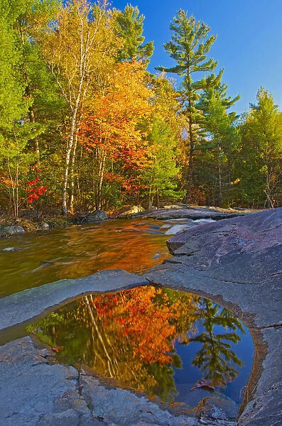 Canada, Ontario. Fall reflections on Rosseau River at Lower Rosseau Falls. Credit as