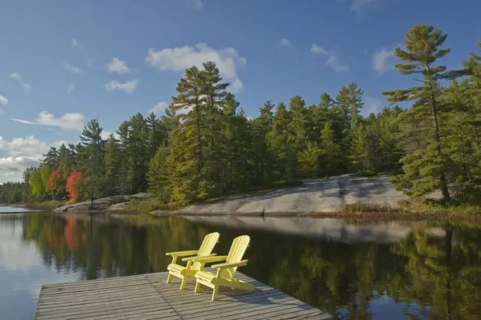 Framed Print : Canada, Ontario, Grundy Lake Provincial Park. Muskoka chairs on lake dock