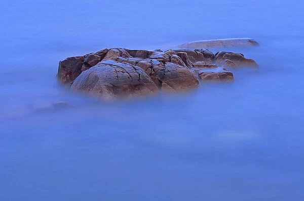 Canada, Ontario, Killarney Provincial Park. Waves and shoreline rocks at dusk. Credit as