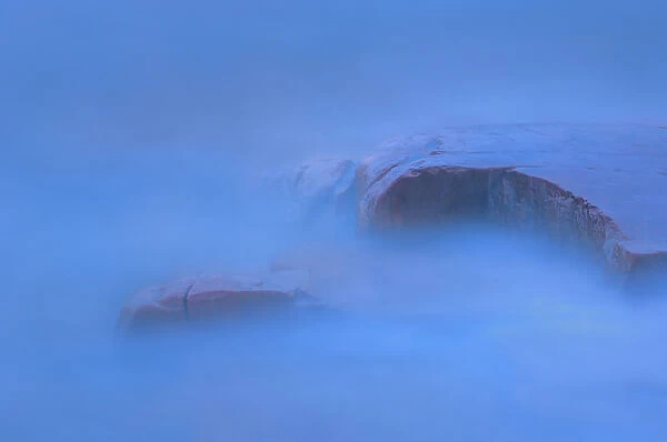 Canada, Ontario, Killarney Provincial Park. Waves and shoreline rocks at dusk. Credit as