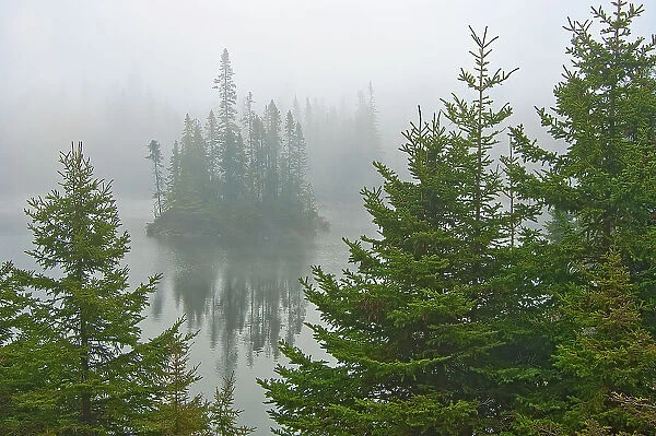 Canada, Ontario, Lake Superior Provincial Park. Fog on island in Fenton Lake