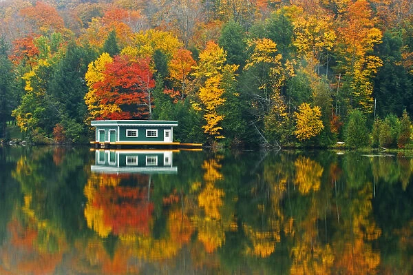 Canada, Ontario, Rosseau. Boathouse and reflection in autumn