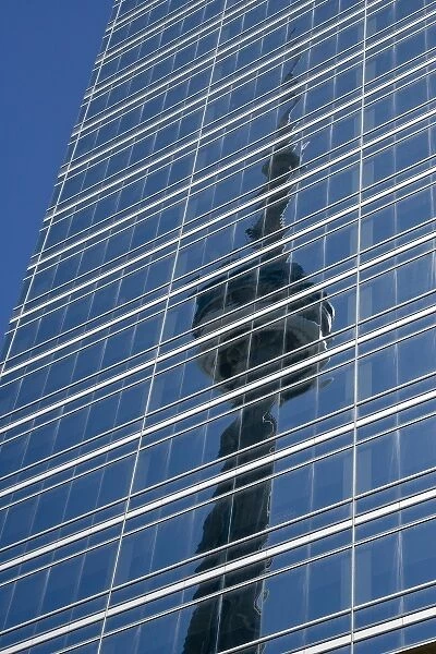 Canada, Ontario, Toronto. Reflection of CN Tower on glass side of skyscraper