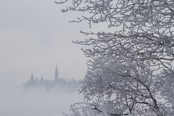 Canada, Ottawa, Ottawa River. Parliament buildings seen through fog