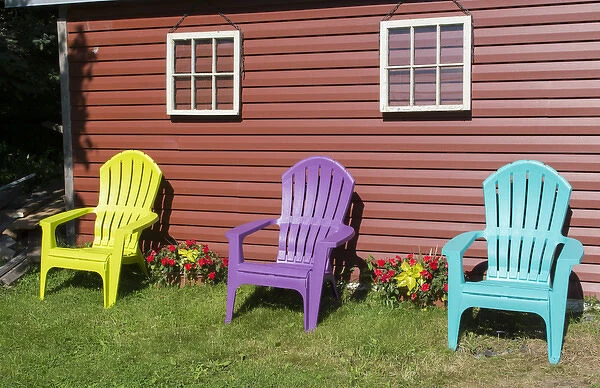 Canada Peggys Cove Nova Scotia barn with colorful Adirondack chairs with flowers