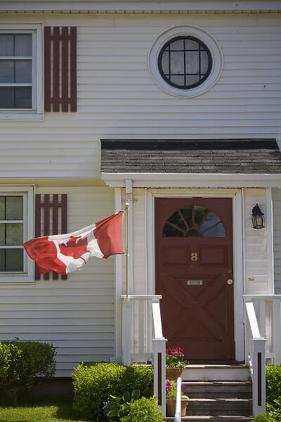 Canada, Prince Edward Island, Charlottetown. Historic home flying Canadian flag