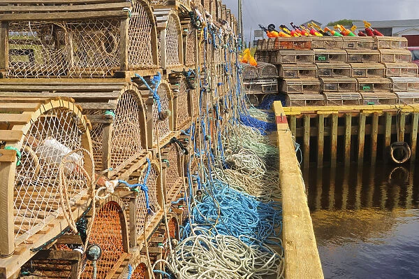Canada, Prince Edward Island, Seacow Pond. Stacked lobster traps and buoys. Credit as
