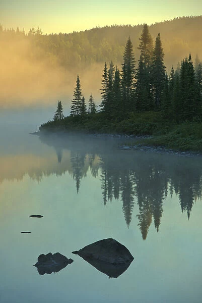 Canada, Quebec, Chibougamau. Lake in fog at sunrise. Credit as