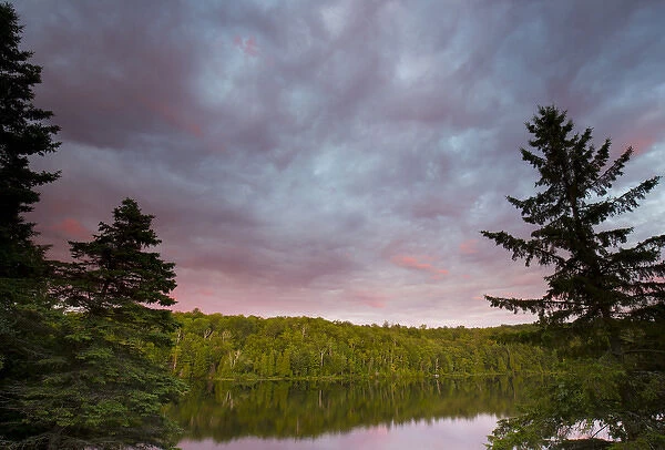 Canada, Quebec, Lake Long Pond. Sunset on lake and forest