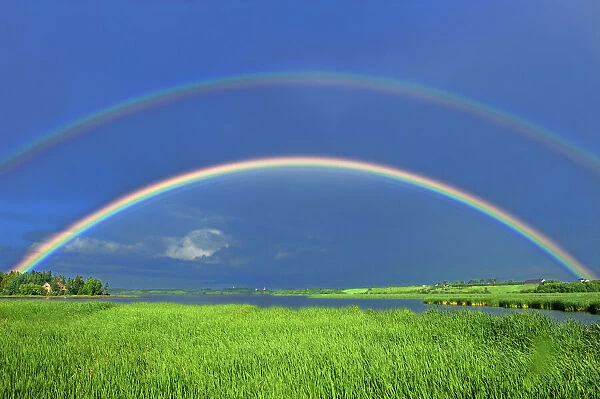 Canada, Quebec, St. Gedeon. Double rainbow after storm