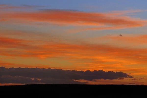 Canada, Saskatchewan, Grasslands National Park. Sunset over prairie grasslands. Credit as