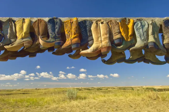 Framed Print : Canada, Saskatchewan, Great Sand Hills. Old cowboy boots on posts on prairie. Credit as Framed Print : Canada, Saskatchewan, Great Sand Hills. Old cowboy boots on posts on prairie. Credit as