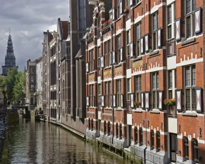 Framed Print : a canal view with colorful buildings and a spire in the distance Framed Print : a canal view with colorful buildings and a spire in the distance