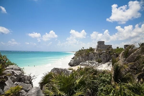 Cancun, Quintana Roo, Mexico - A white sand beach behind tropical foliage. An old