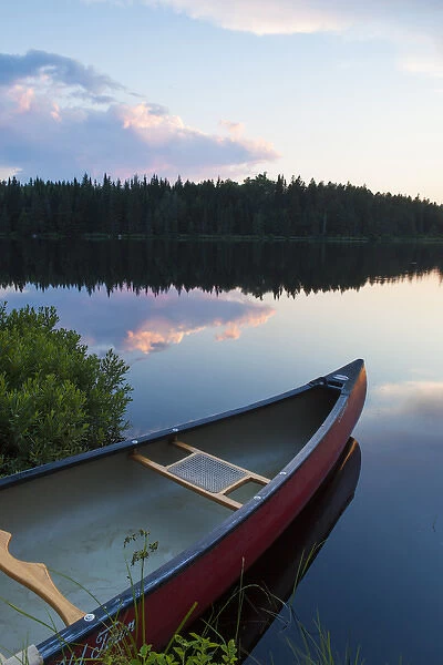 A canoe on Little Berry Pond in Maines Northern Forest. Sunset. Cold Stream watershed