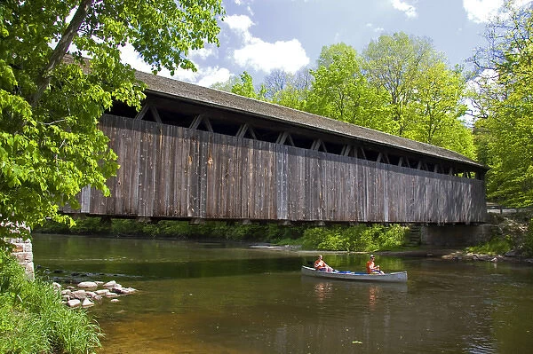 Canoe passing under the Whites Bridge on the Flat River in Keene Township, Michigan
