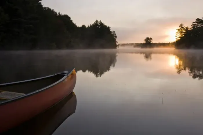 Framed Print : A canoe rests on the shore of Pawtuckaway Lake at dawn as seen from Horse Island Framed Print : A canoe rests on the shore of Pawtuckaway Lake at dawn as seen from Horse Island