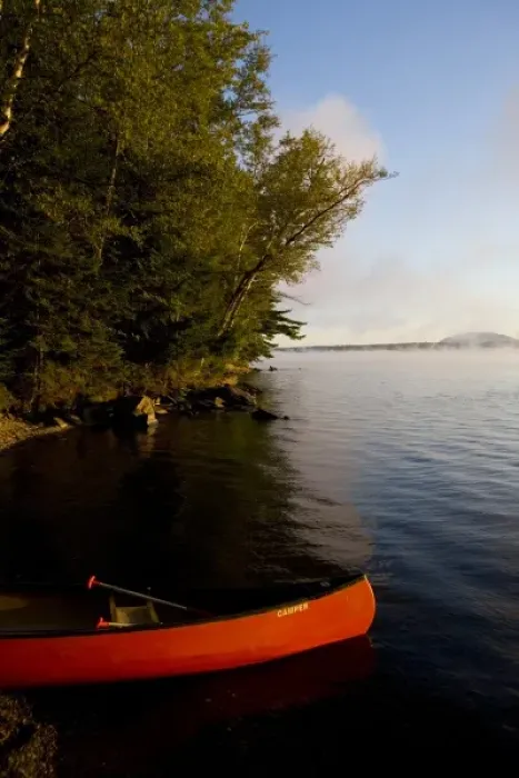 Framed Print : A canoe on shore in Lily Bay on Moosehead Lake Maine USA