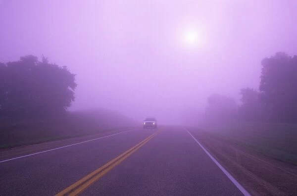 Car driving in fog