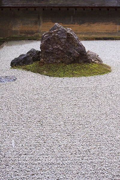 The carefully placed rocks and raked gravel gardens of the Zen garden of Ryoan-Ji Temple in Kyoto