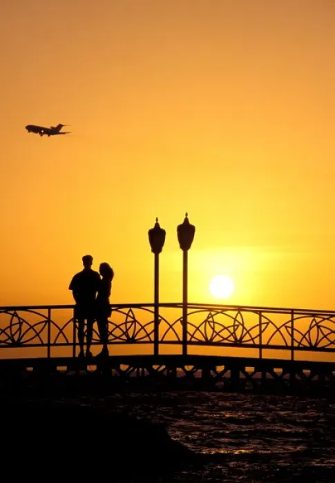 Framed Print : Caribbean, Aruba, Oranjestad. Couple enjoying sunset with plane overhead Framed Print : Caribbean, Aruba, Oranjestad. Couple enjoying sunset with plane overhead