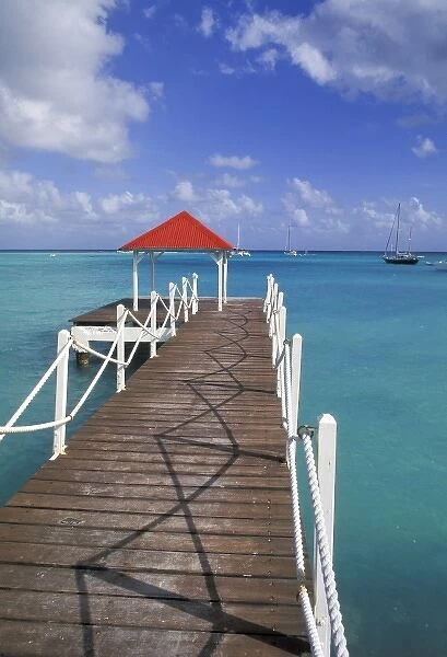 Caribbean, Guadeloupe. Colorful dock and crystal blue water