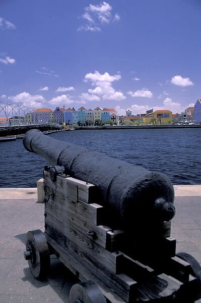 Caribbean, Netherland Antilles, Curacao, Willemstad Fort canon and view of colorful buildings